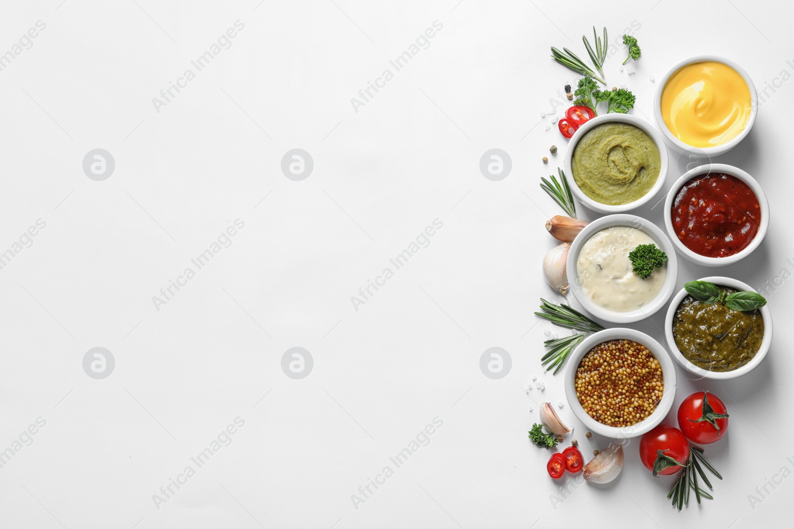 Photo of Composition with different sauces and ingredients on white background, flat lay. Space for text
