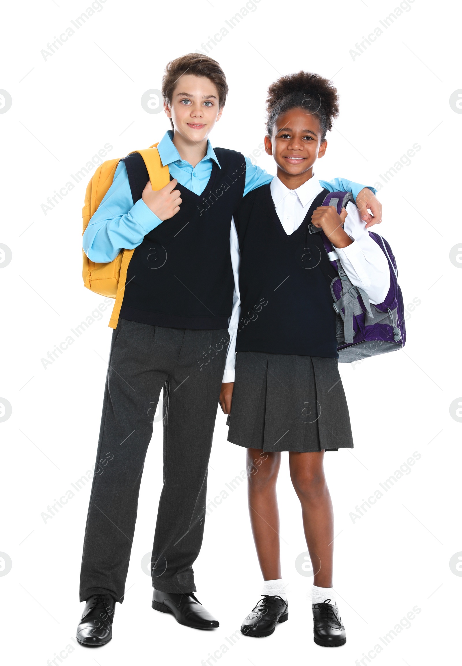 Photo of Happy pupils in school uniform on white background