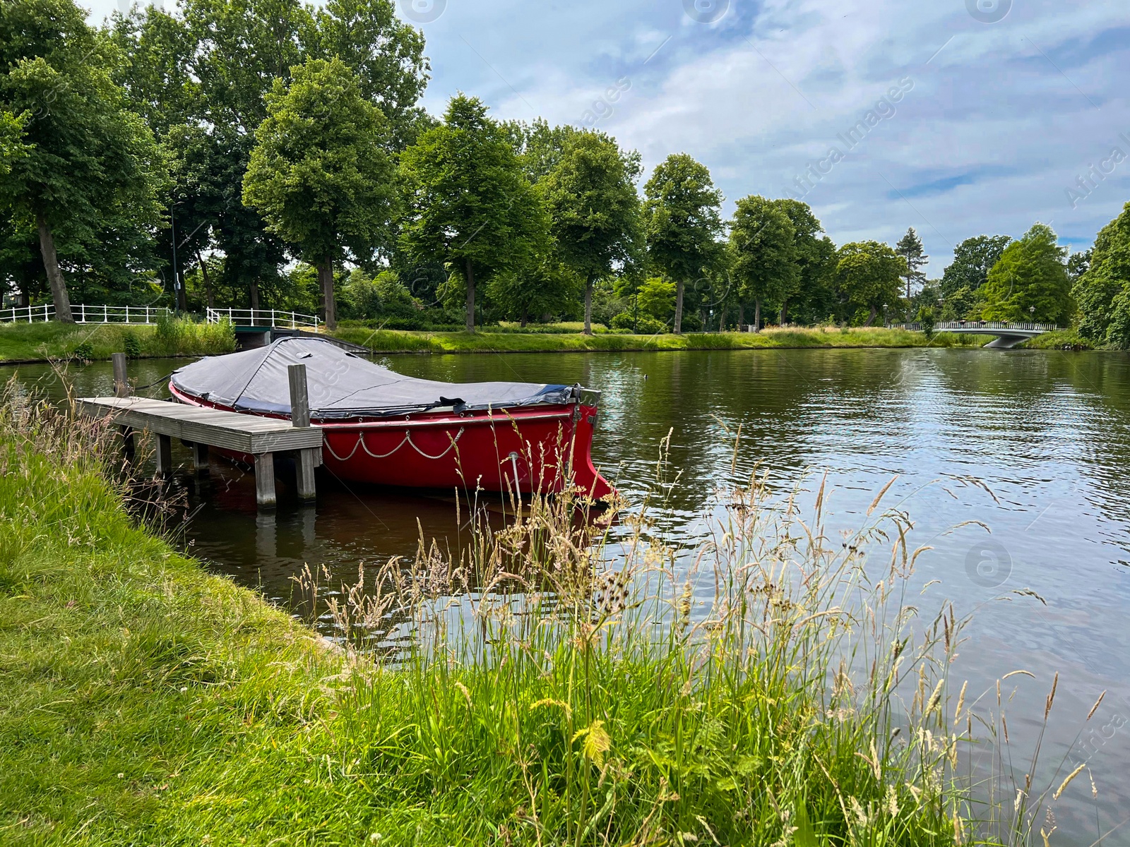 Photo of Beautiful view of canal with moored boat on sunny day