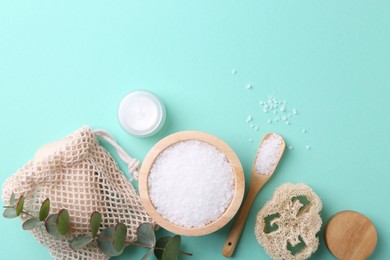 Jar of cream, body care products and eucalyptus branch on turquoise background, flat lay. Space for text