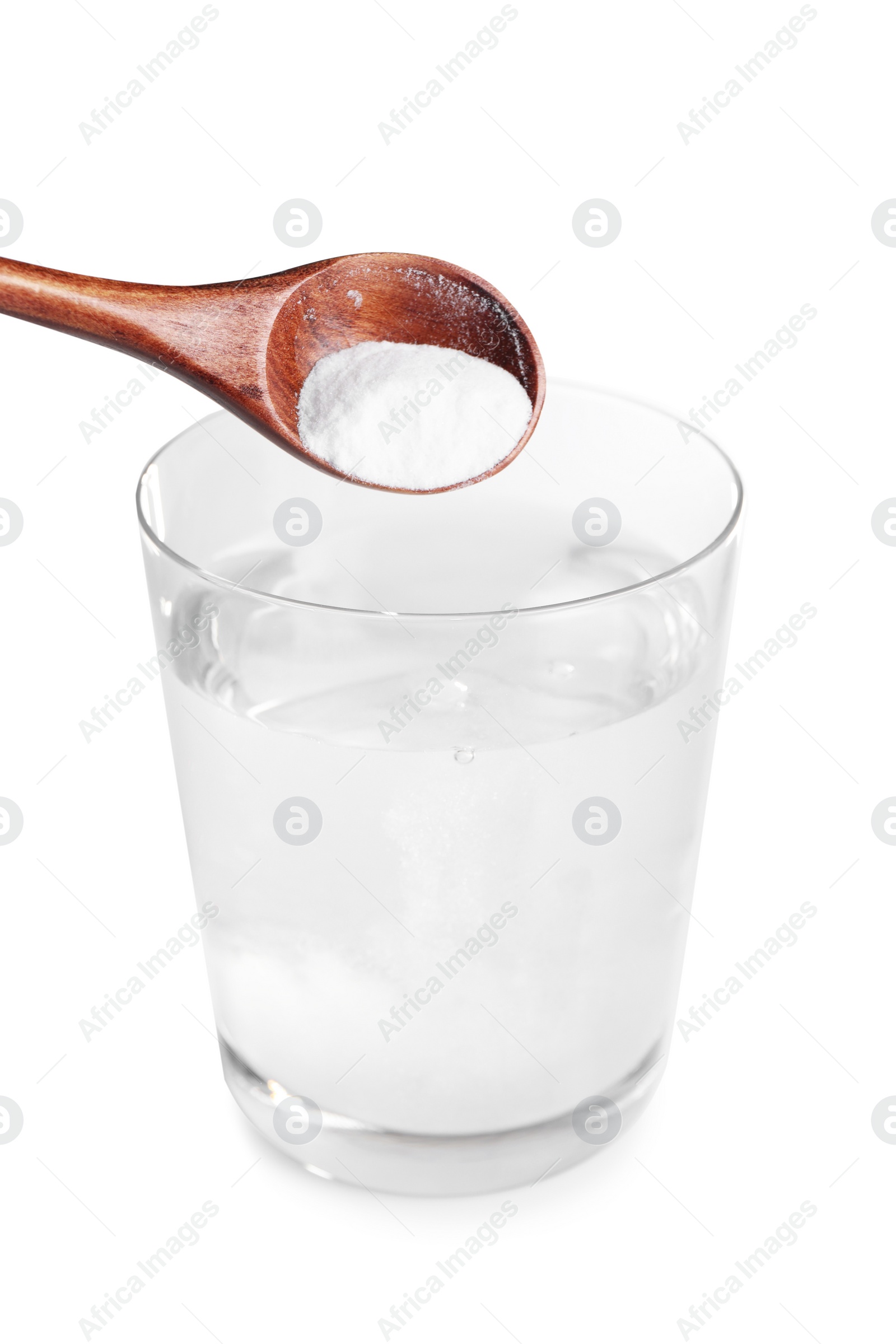 Photo of Adding baking soda into glass of water on light background