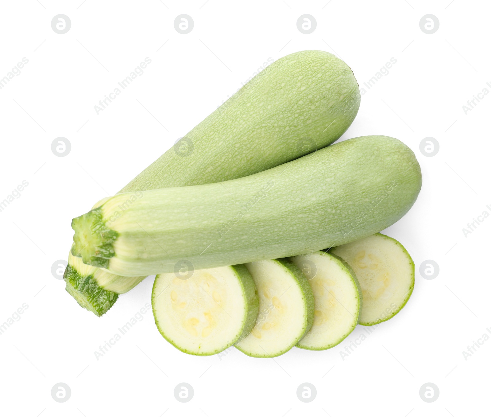 Photo of Cut and whole green ripe zucchinis on white background, top view