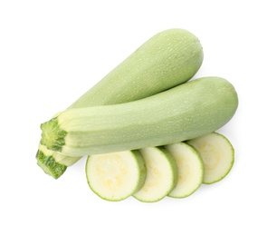 Photo of Cut and whole green ripe zucchinis on white background, top view