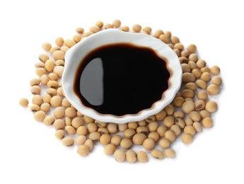 Bowl of soy sauce and beans on white background