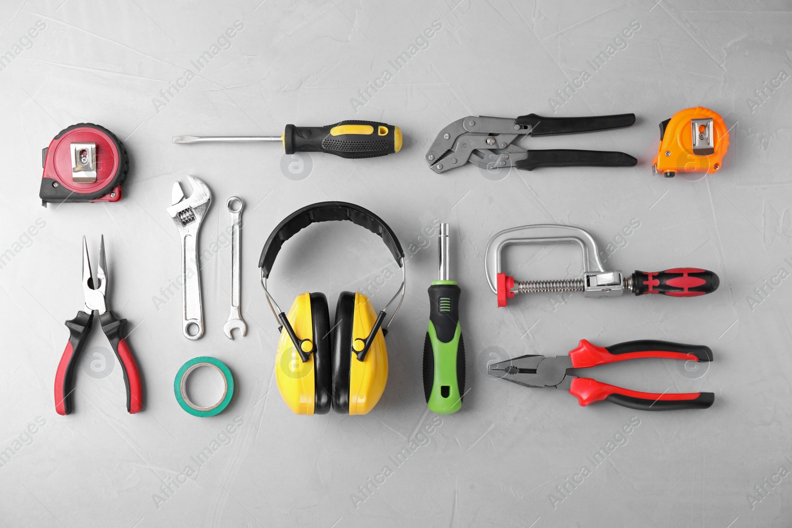 Photo of Flat lay composition with different construction tools on grey background