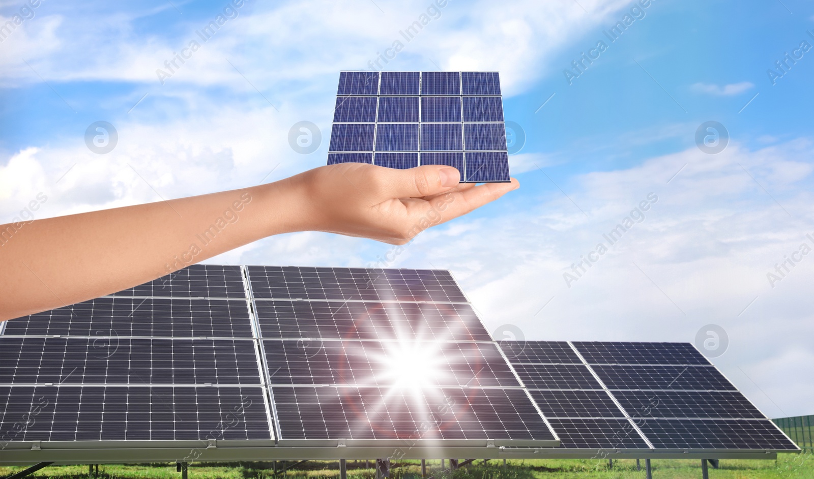 Image of Woman demonstrating solar panel outdoors, closeup. Alternative energy source 