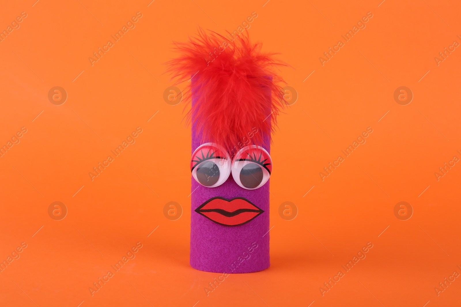 Photo of Purple monster on orange background. Halloween decoration