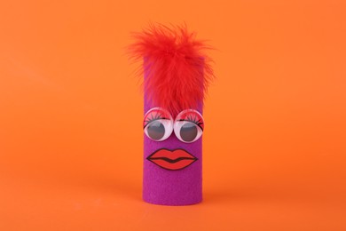 Photo of Purple monster on orange background. Halloween decoration