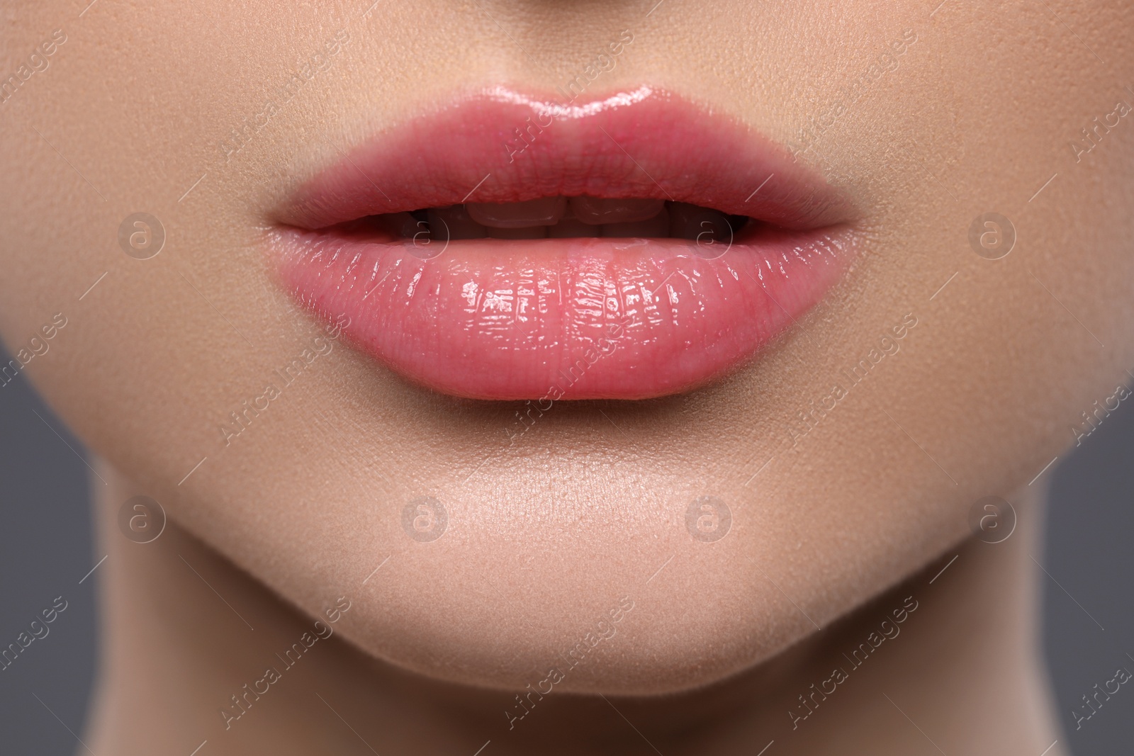 Photo of Young woman with beautiful plump lips, closeup