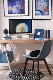 Photo of Modern workplace interior with computer on table