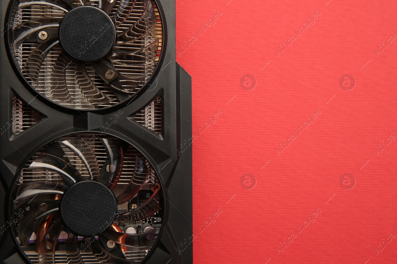 Photo of One graphics card on red background, top view. Space for text