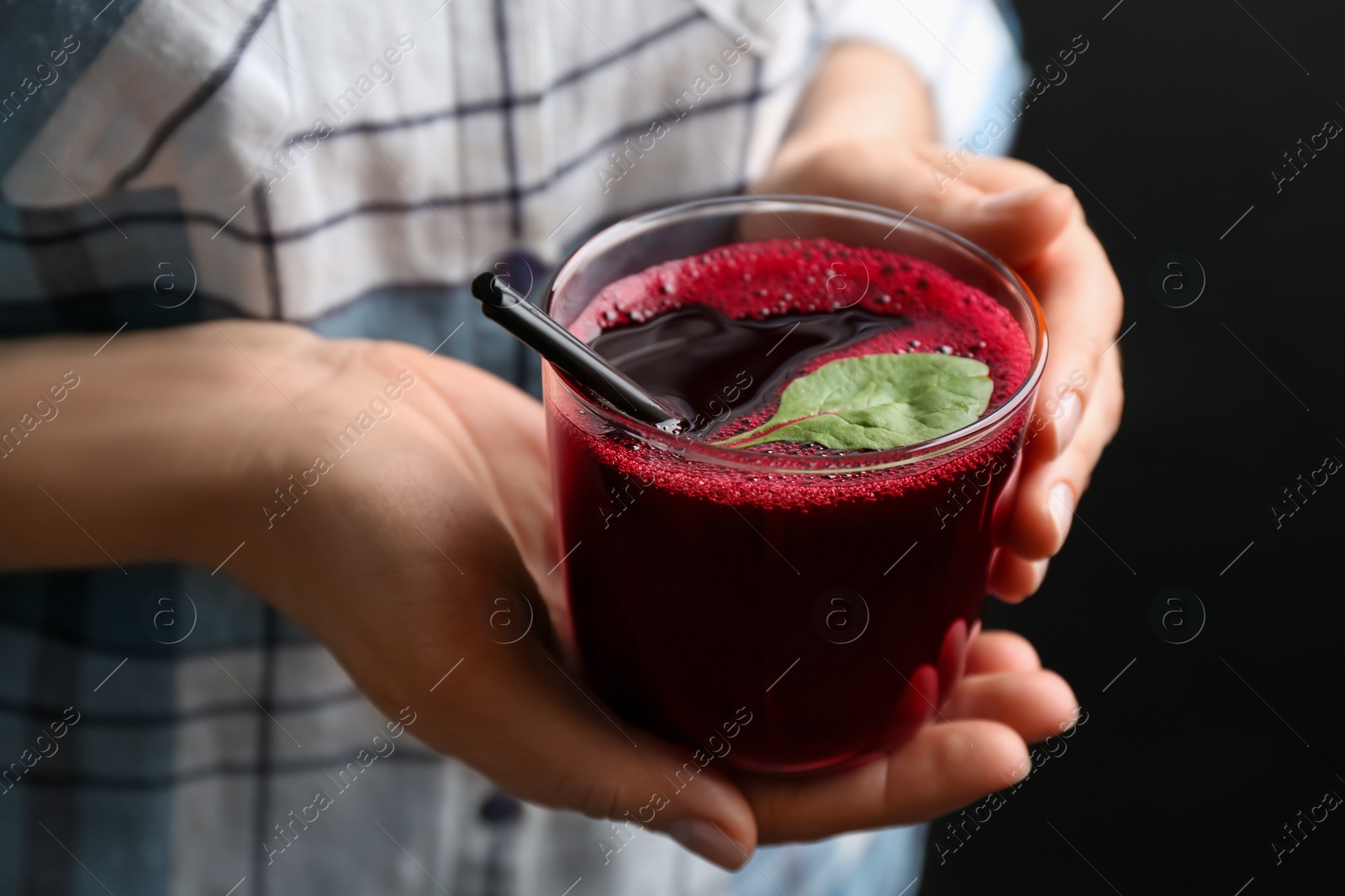 Photo of Woman with glass of fresh beet juice, closeup