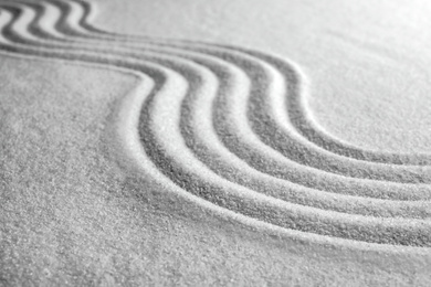Photo of White sand with pattern as background. Zen, meditation, harmony