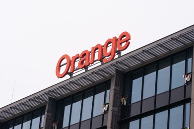 Photo of Warsaw, Poland - September 10, 2022: Building with modern Orange logo