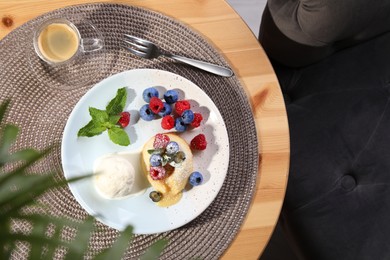 Photo of Delicious vanilla fondant served with ice cream and berries on table, flat lay