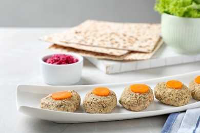 Plate of traditional Passover (Pesach) gefilte fish on table