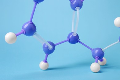 Molecule of phenylalanine on light blue background, closeup. Chemical model
