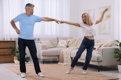 Happy affectionate couple dancing at home. Romantic date