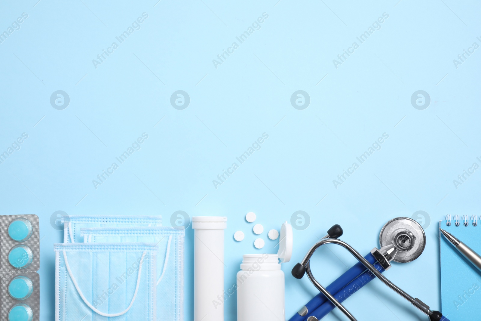 Photo of Flat lay composition with medical items on light blue background. Space for text