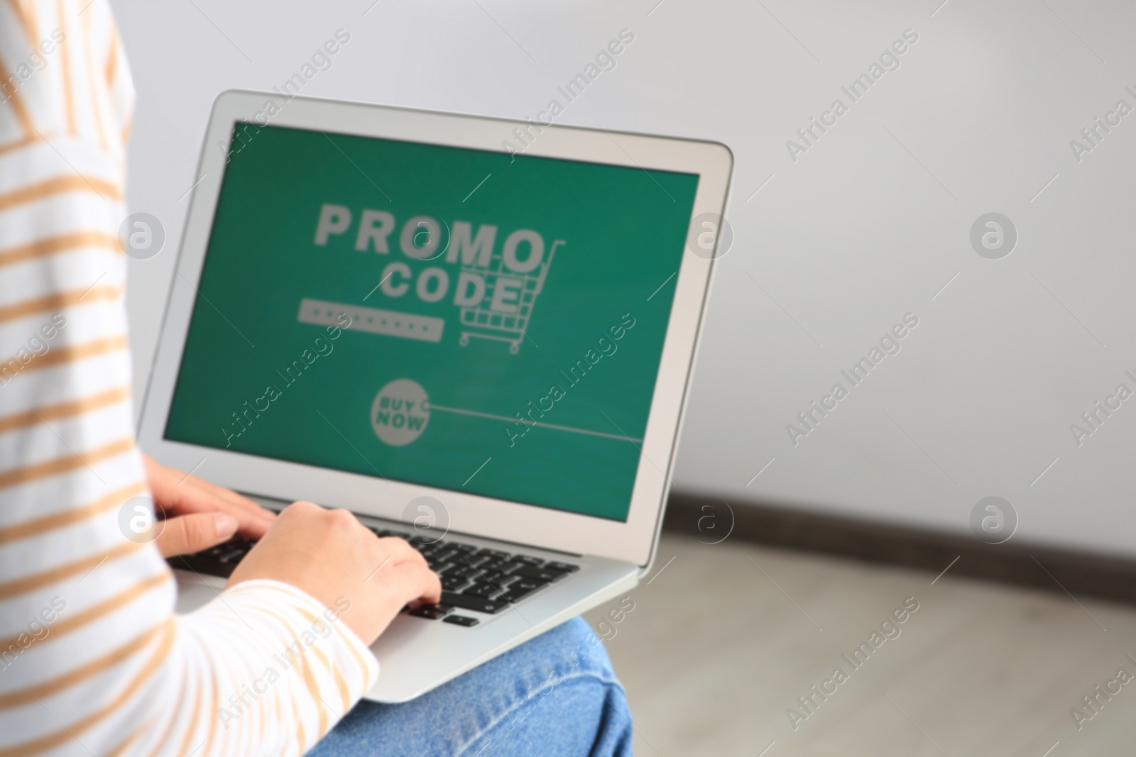 Photo of Woman with laptop activating promo code while doing online shopping indoors, closeup. Space for text