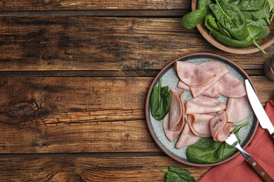 Photo of Tasty ham served on wooden table, flat lay. Space for text