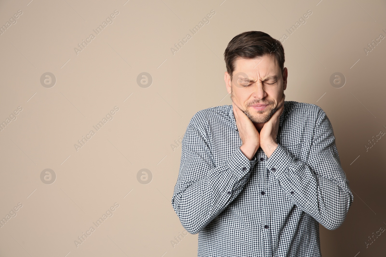 Photo of Man suffering from cough on color background. Space for text