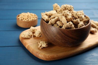 Dehydrated soy meat chunks on blue wooden table