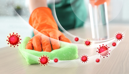 Image of Cleaning vs viruses. Woman washing table with sponge and disinfecting solution