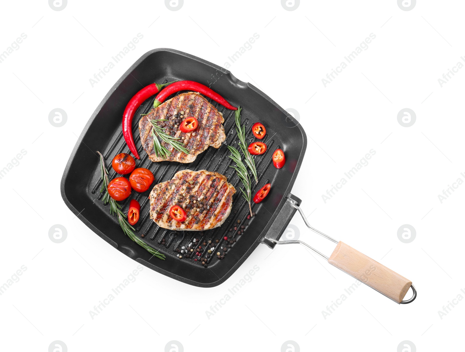 Photo of Grill pan with delicious pork steaks, spices and vegetables isolated on white, top view