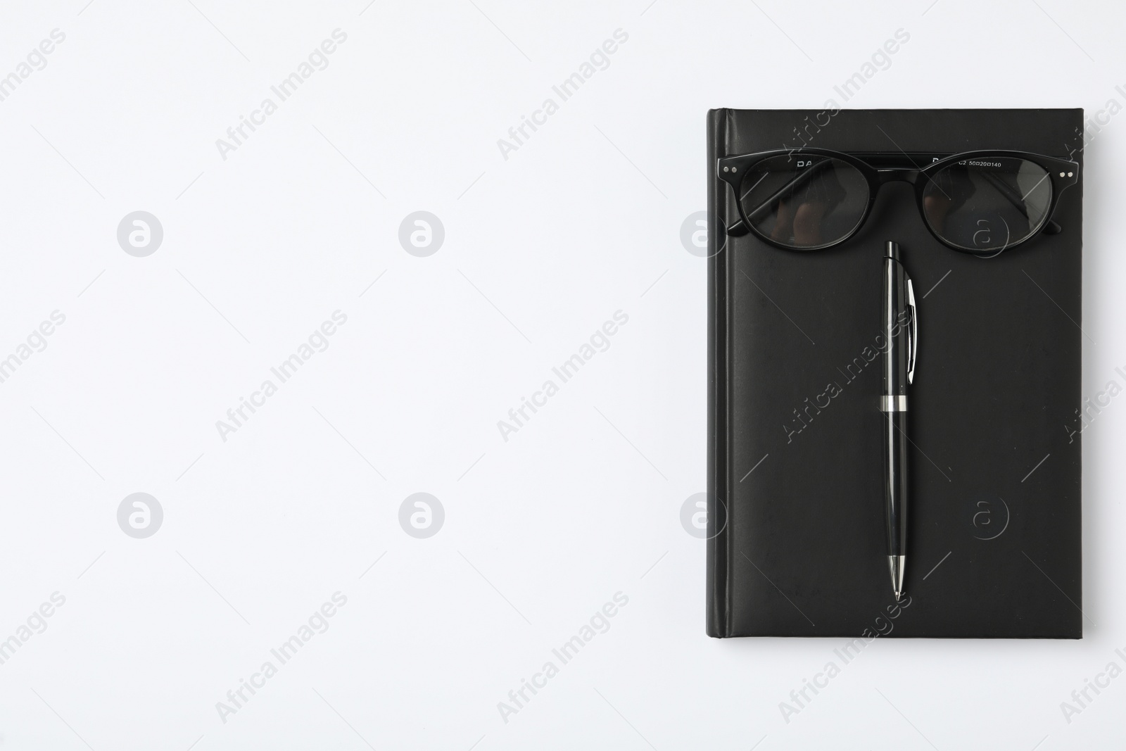 Photo of Notebook, pen and eyeglasses on white background, flat lay with space for text. Teacher's Day