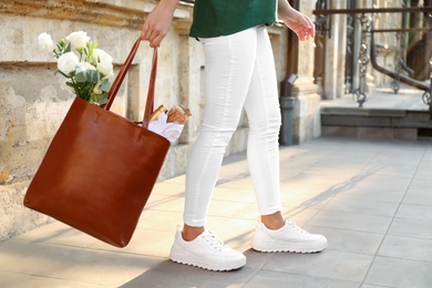 Photo of Woman with leather shopper bag outdoors, closeup