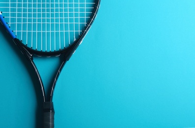 Photo of Tennis racket on blue background, top view. Space for text