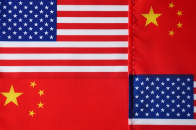 Photo of USA and China flags as background, top view. International relations