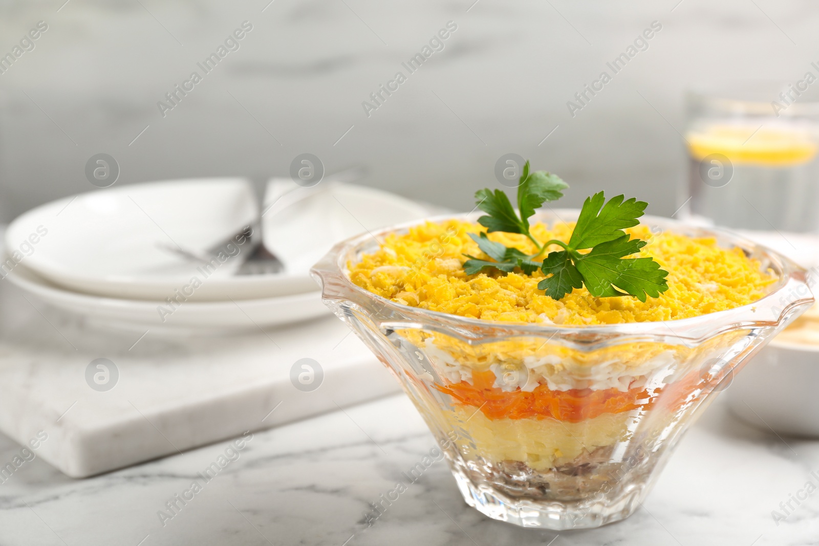 Photo of Traditional russian salad Mimosa served on white marble table. Space for text