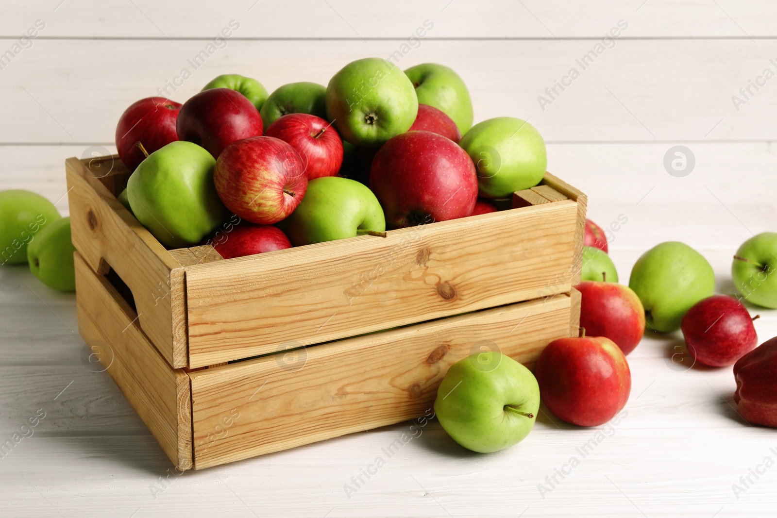 Photo of Fresh ripe red and green apples on white wooden table