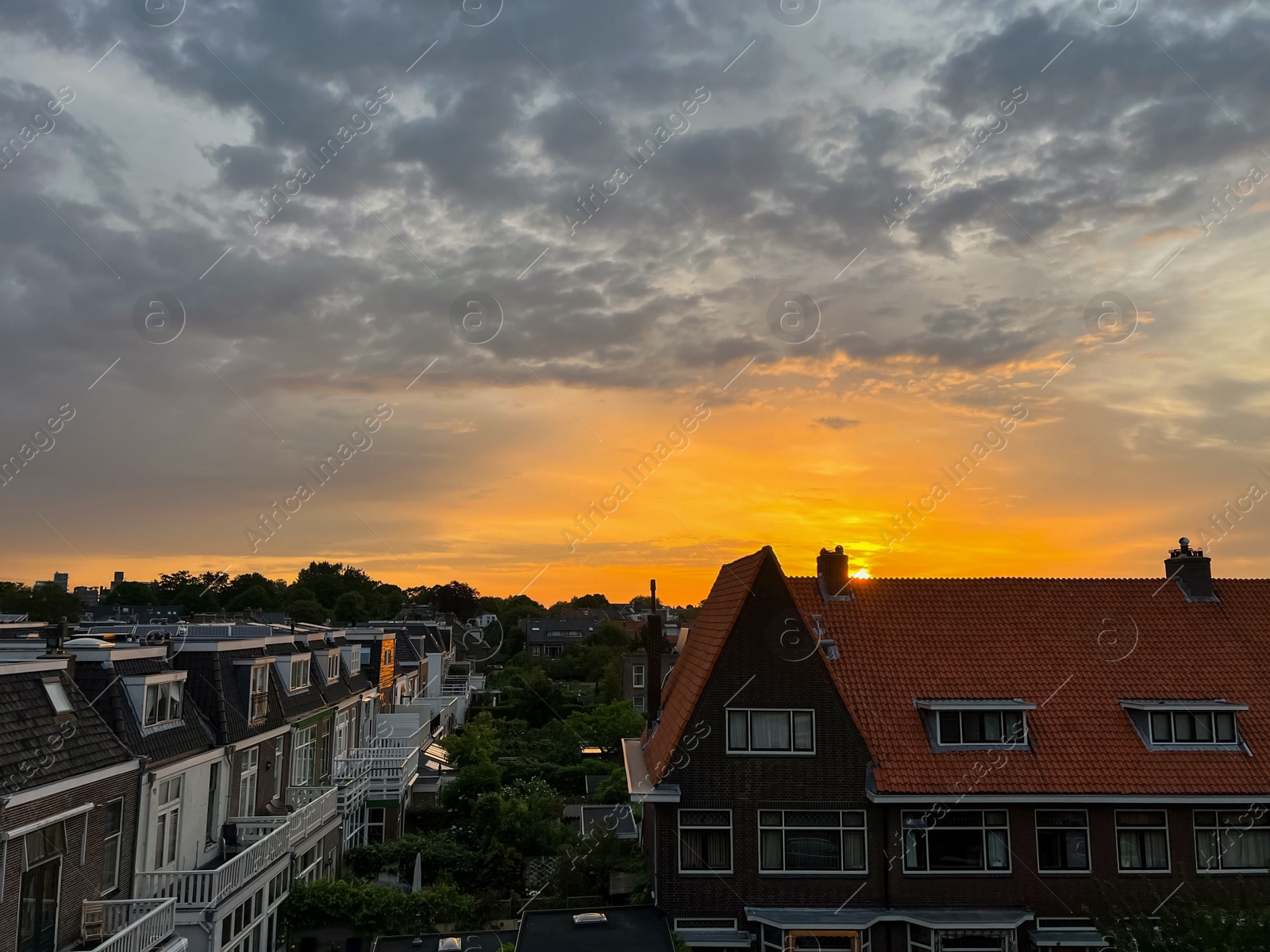 Photo of Picturesque view of city street with beautiful buildings at sunrise