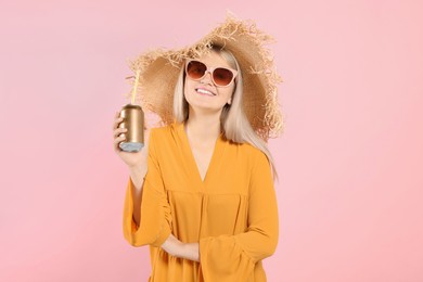 Photo of Beautiful happy woman holding beverage can on pink background
