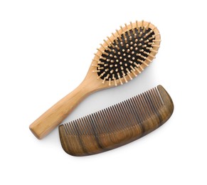 Photo of New wooden hair brush and comb on isolated white, top view