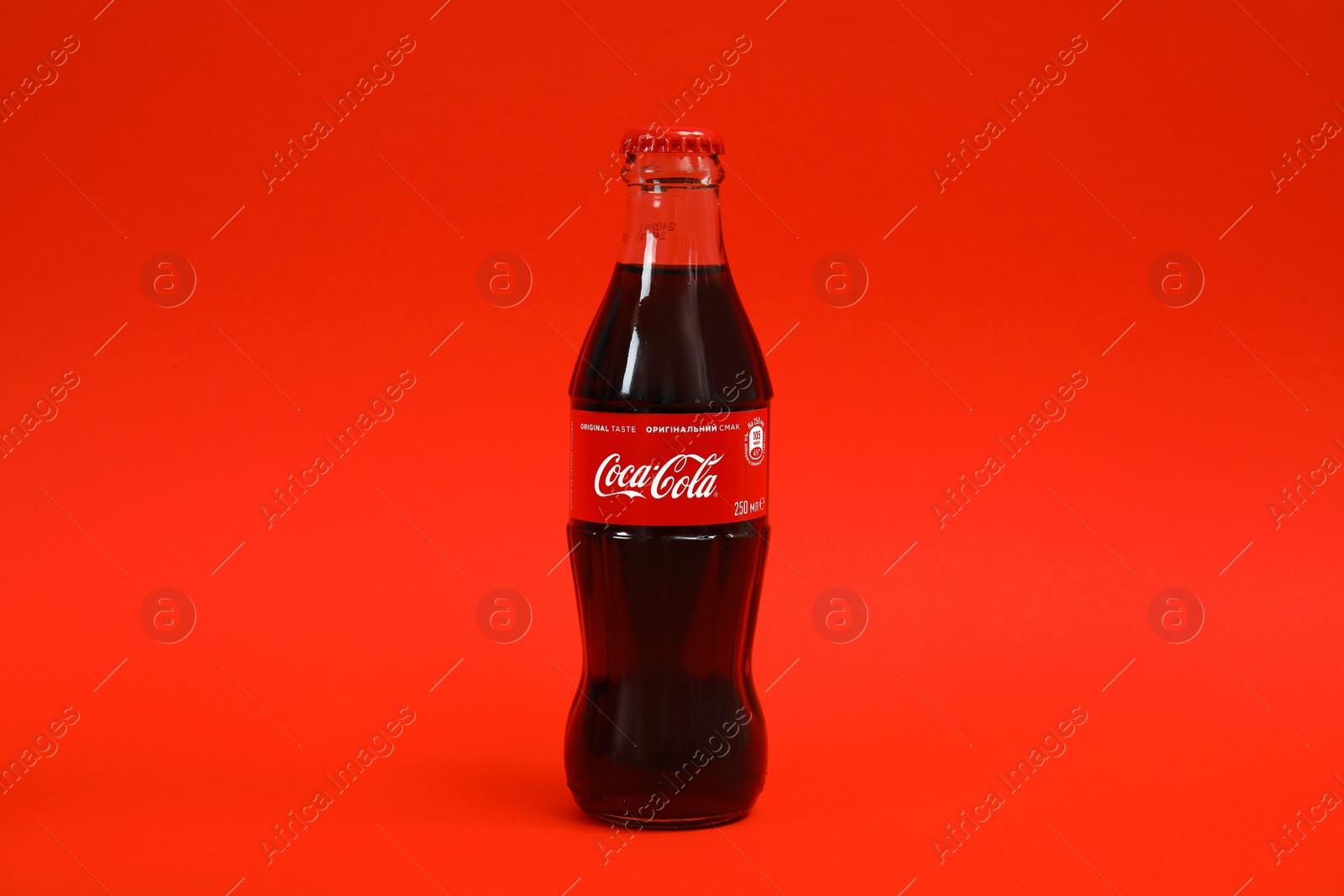 Photo of MYKOLAIV, UKRAINE - NOVEMBER 14, 2018: Bottle of Coca-Cola on color background