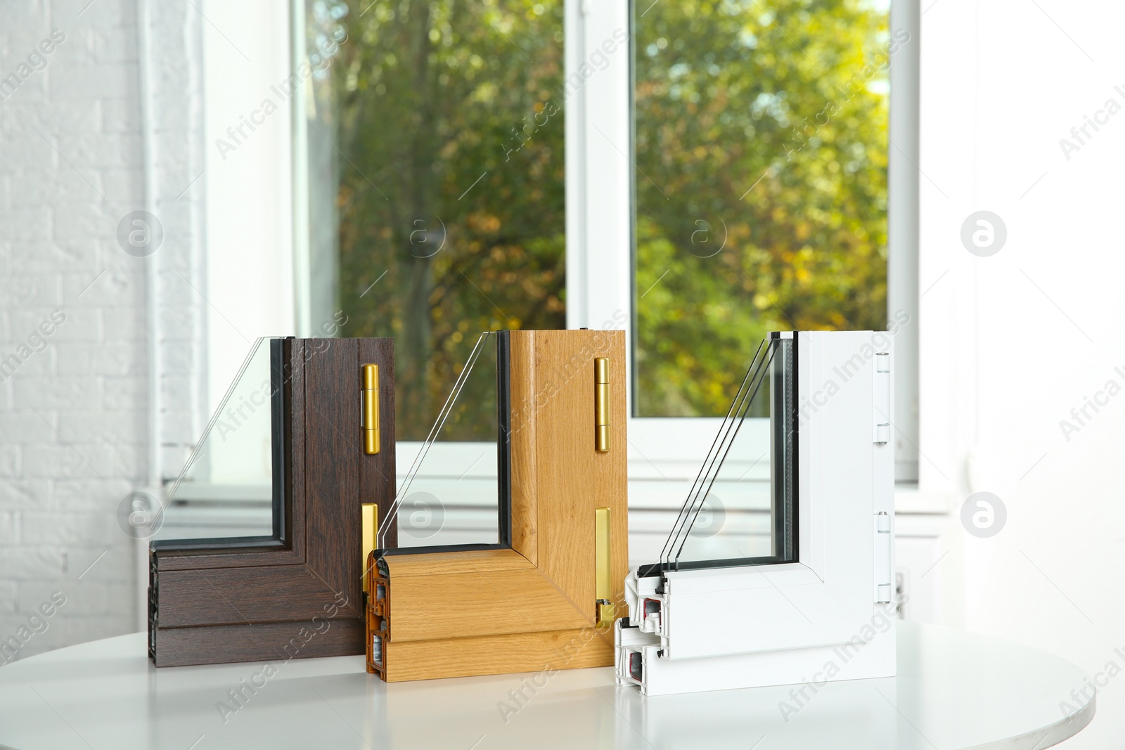 Photo of Samples of modern window profiles on table indoors. Installation service