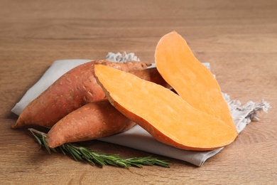 Photo of Composition with ripe sweet potatoes on wooden table