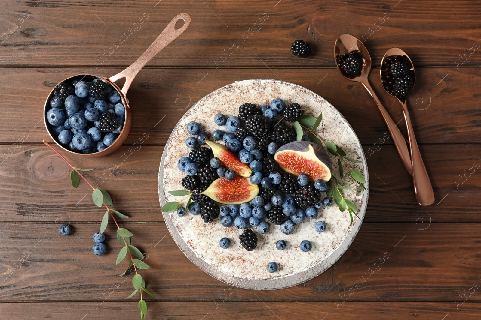 Photo of Delicious homemade cake with fresh berries served on wooden table, flat lay