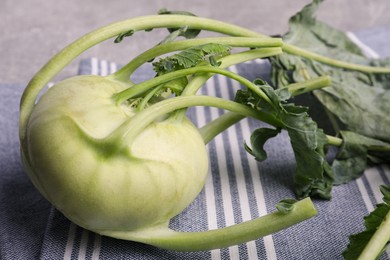 Photo of Whole fresh ripe kohlrabi plant on table, closeup