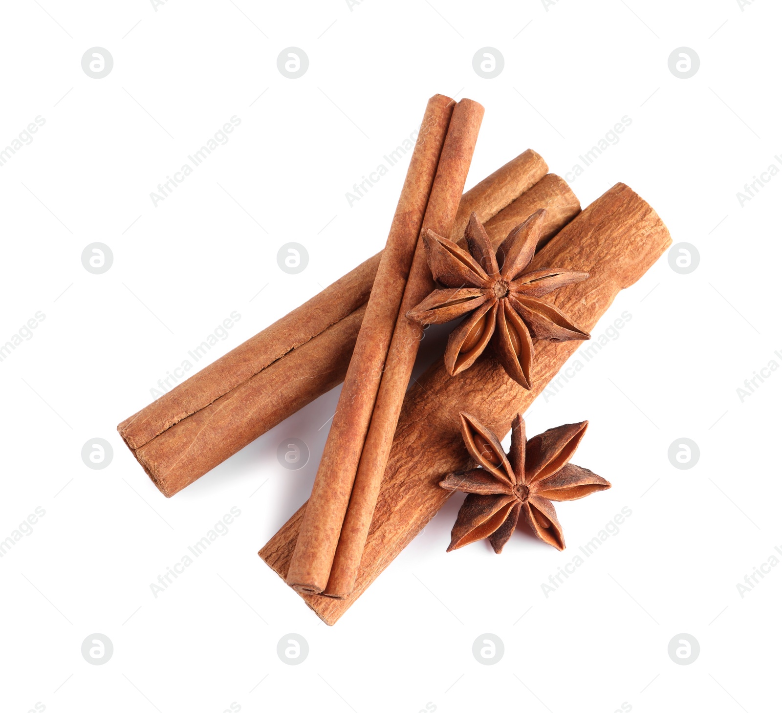 Photo of Cinnamon sticks and anise stars isolated on white, top view