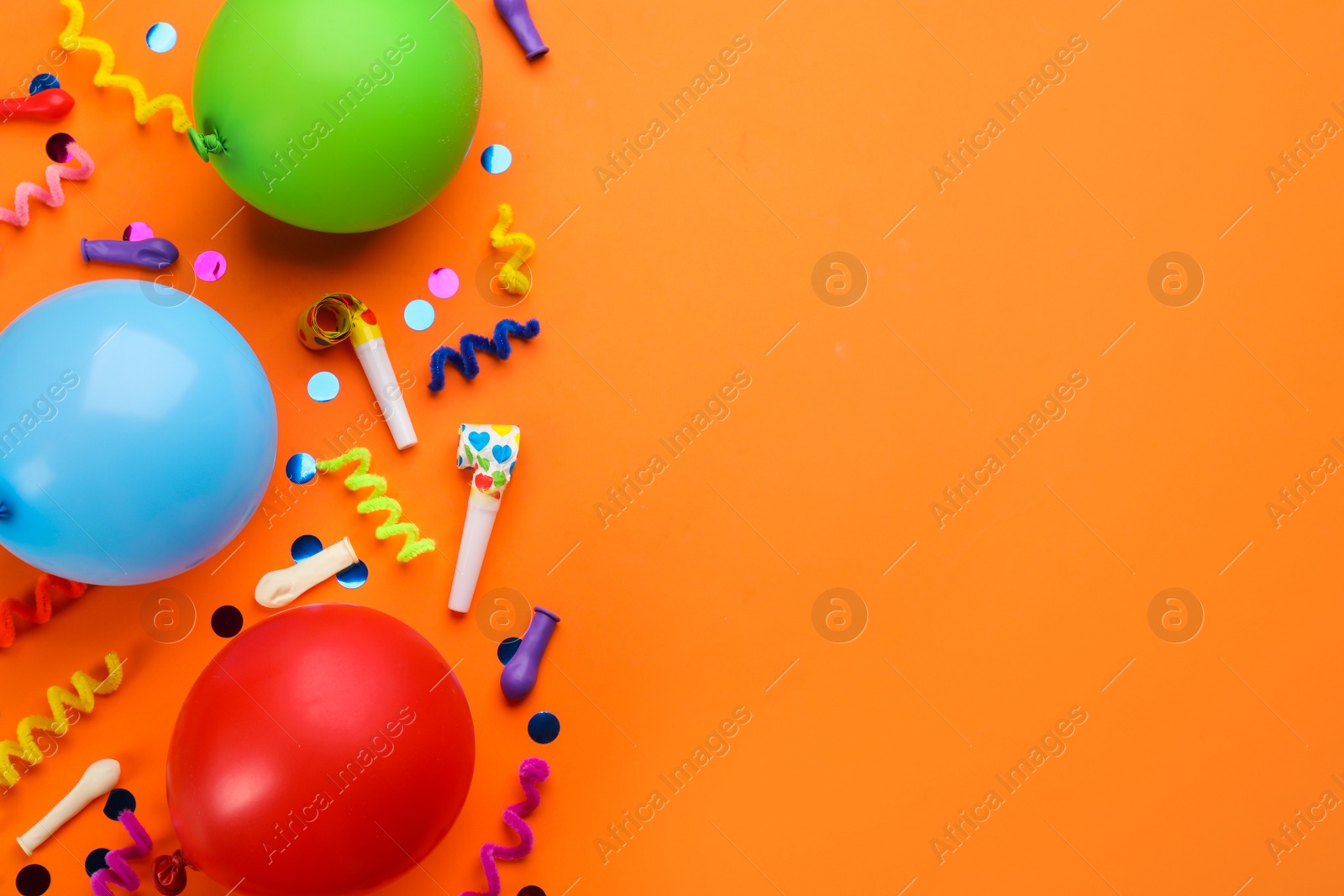 Photo of Flat lay composition with carnival items on orange background. Space for text