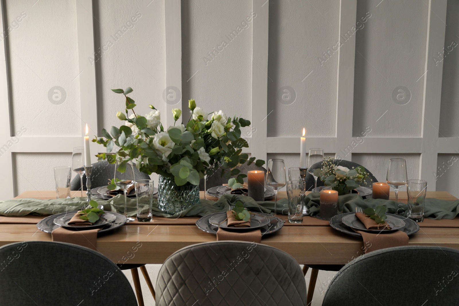 Photo of Festive table setting with beautiful floral decor indoors