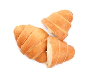 Photo of Delicious croissants with cream on white background, top view