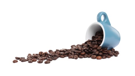 Coffee beans and overturned light blue cup isolated on white