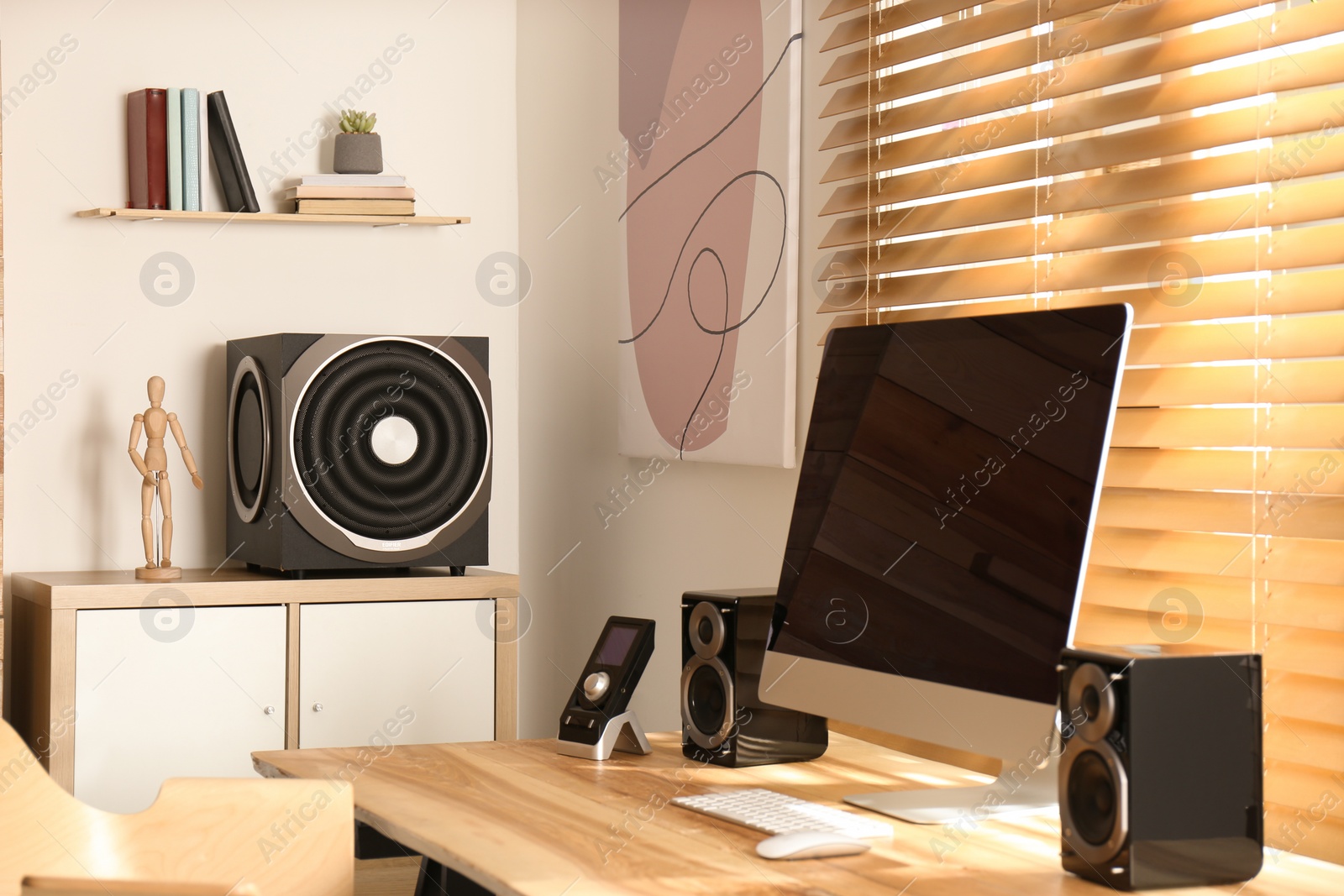 Photo of Modern computer with audio speaker system in bright room