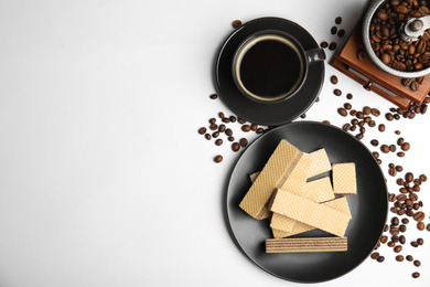 Breakfast with delicious wafers and coffee on white background, flat lay. Space for text
